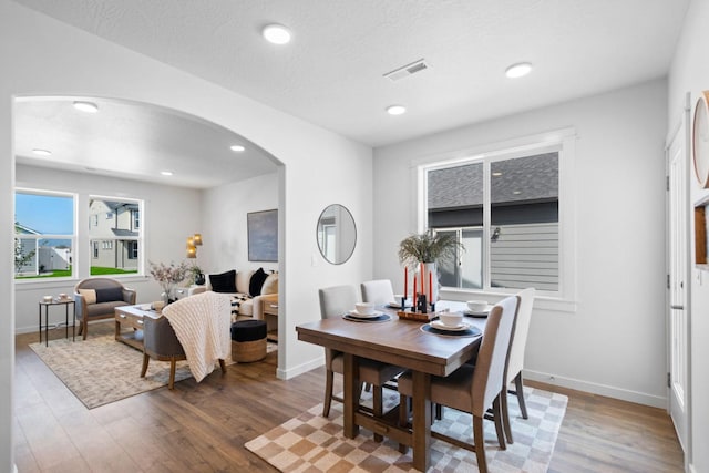 5843 Horn Rd, Missoula, MT 59808 - dining room featuring arched walkways, wood finished floors, and recessed lighting