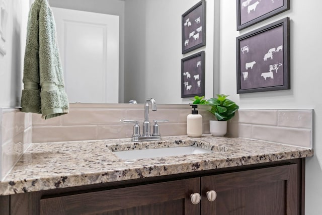 bathroom with tasteful backsplash and vanity