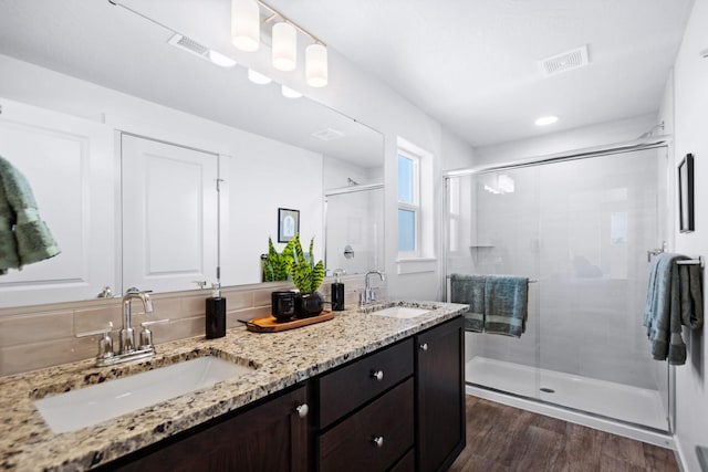 bathroom featuring hardwood / wood-style flooring, an enclosed shower, and vanity