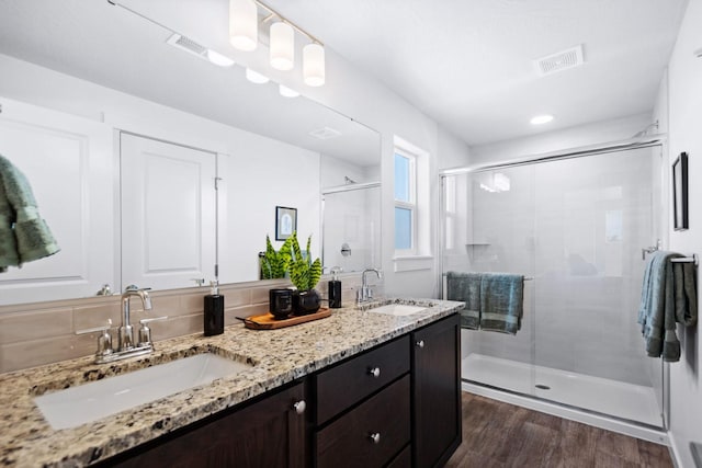 5843 Horn Rd, Missoula, MT 59808 - bathroom featuring double vanity, a stall shower, wood finished floors, and recessed lighting
