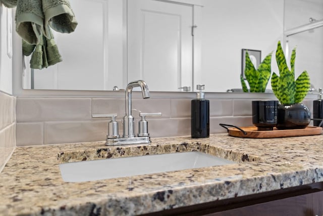 bathroom with tasteful backsplash and vanity