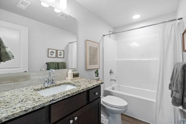 full bathroom featuring shower / bath combo with shower curtain, hardwood / wood-style floors, toilet, and vanity