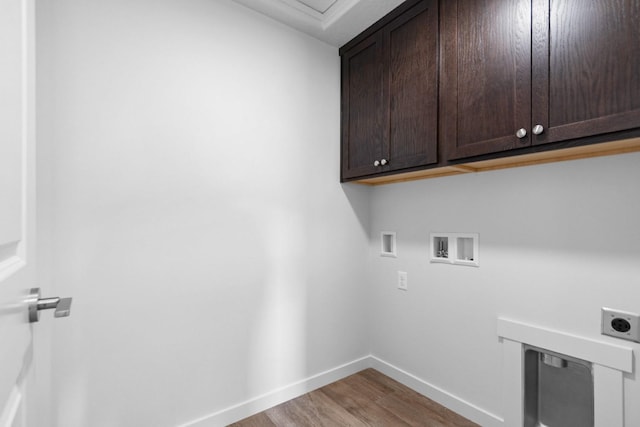 laundry area featuring washer hookup, wood-type flooring, hookup for an electric dryer, and cabinets