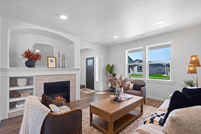 5843 Horn Rd, Missoula, MT 59808 - living room with a brick fireplace, arched walkways, wood finished floors, and recessed lighting