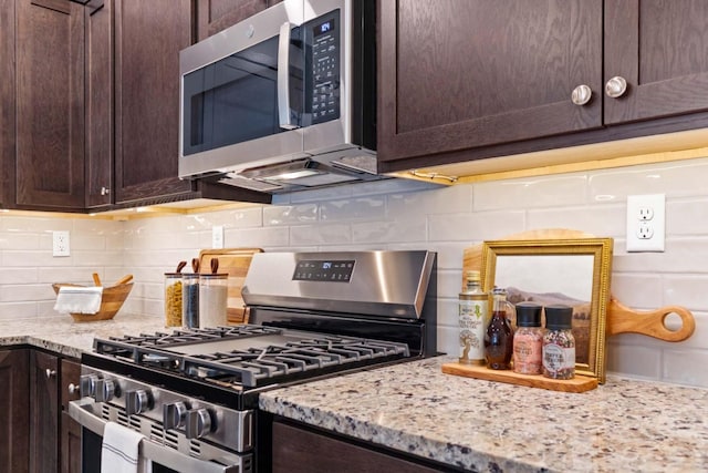 kitchen featuring appliances with stainless steel finishes, tasteful backsplash, dark brown cabinetry, and light stone countertops