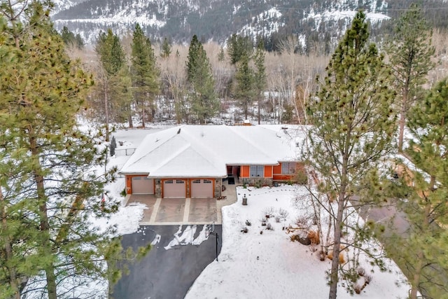 snowy aerial view featuring a mountain view