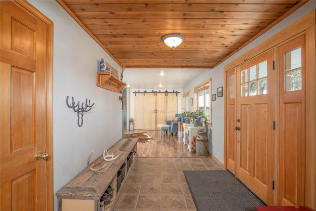 foyer entrance featuring crown molding and wood ceiling