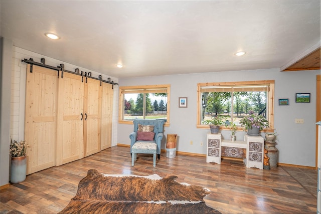 7 Hardy Cir, Ennis, MT 59729 - sitting room with a barn door, wood finished floors, baseboards, and recessed lighting