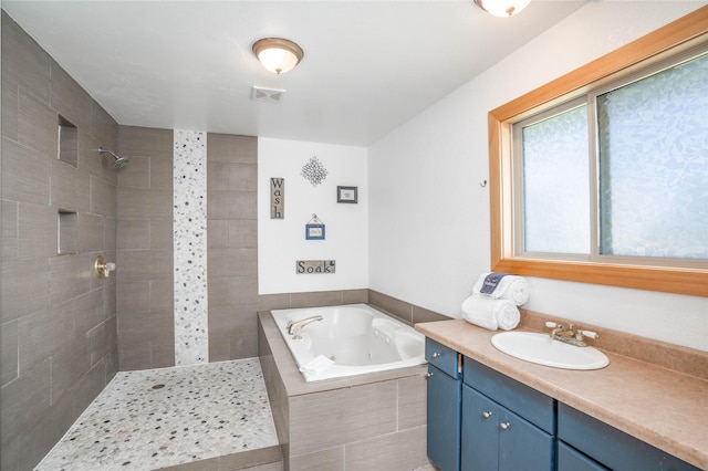 bathroom featuring separate shower and tub and vanity