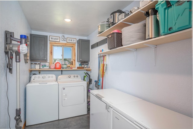 laundry area with washing machine and dryer and cabinets