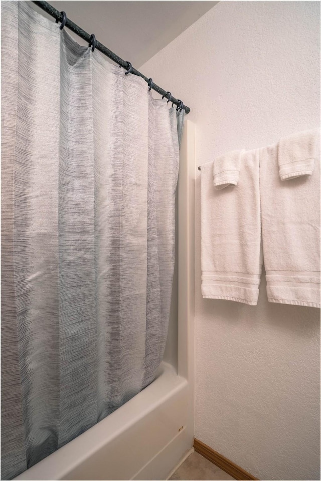 7 Hardy Cir, Ennis, MT 59729 - bathroom featuring shower / bath combo and baseboards