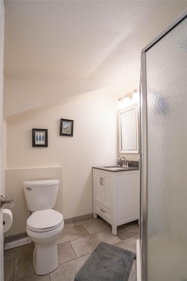 bathroom with toilet, a shower with door, tile patterned floors, a textured ceiling, and vanity