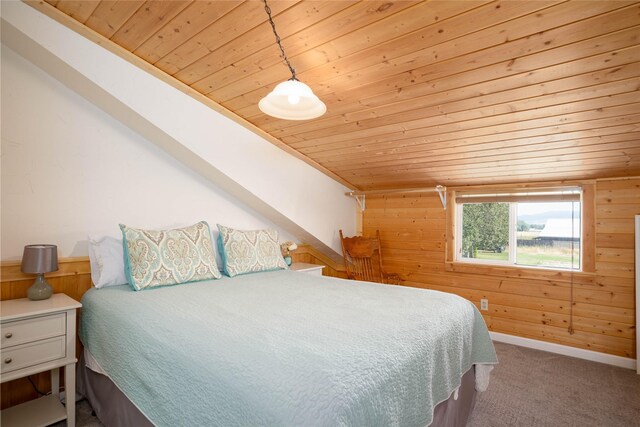 bedroom featuring wooden ceiling, carpet, lofted ceiling, and wooden walls