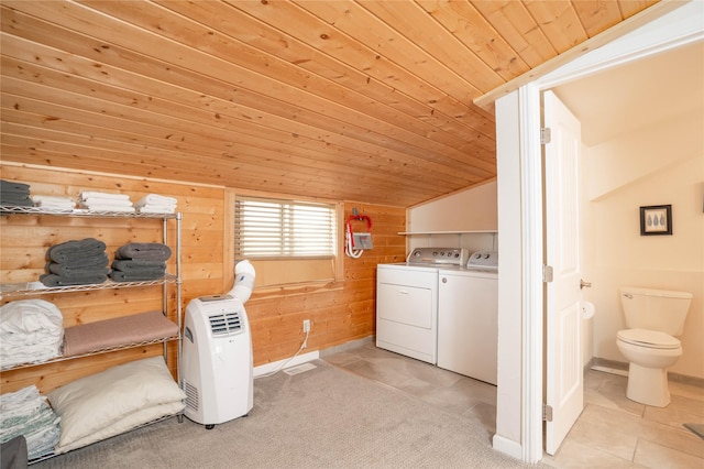 7 Hardy Cir, Ennis, MT 59729 - washroom featuring separate washer and dryer, wooden ceiling, light tile patterned flooring, and wood walls