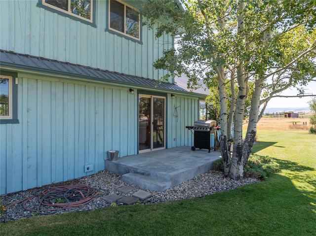 doorway to property with a lawn