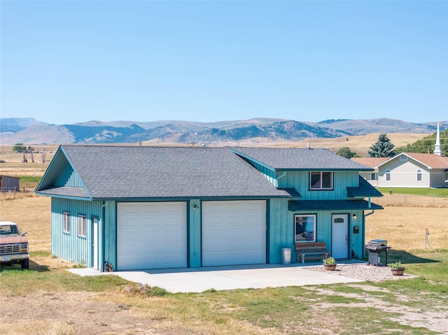 view of front facade featuring a mountain view and a garage