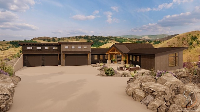 view of front of house with a mountain view, a garage, and a patio