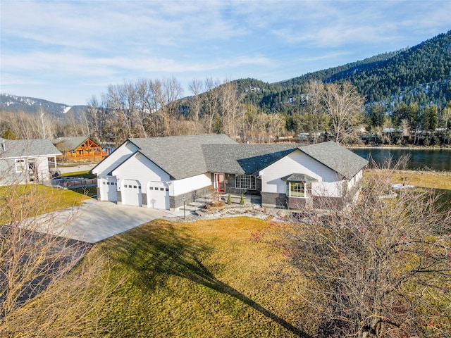 birds eye view of property with a water and mountain view