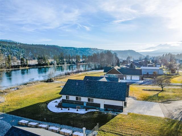 birds eye view of property featuring a water and mountain view