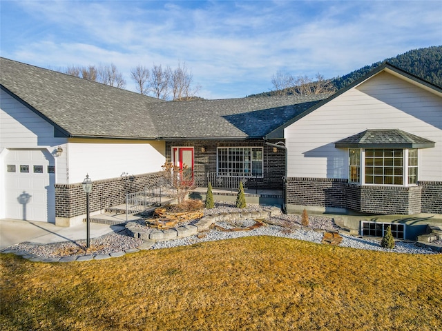 single story home featuring a garage and a front lawn