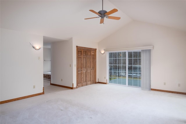 interior space with ceiling fan, lofted ceiling, and light colored carpet