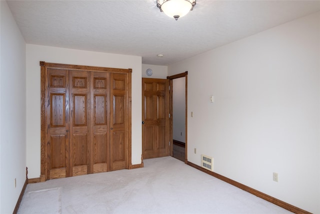 unfurnished bedroom with a closet and carpet