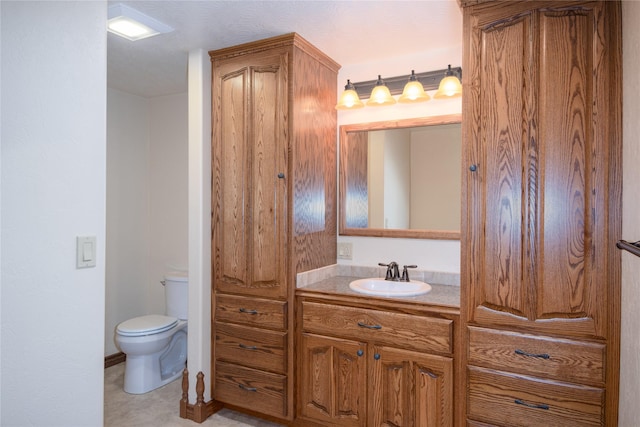 bathroom featuring toilet and vanity