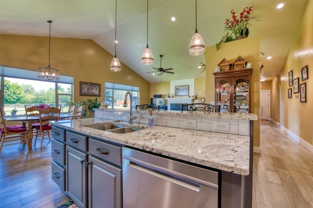 kitchen featuring ceiling fan, dishwasher, sink, and pendant lighting