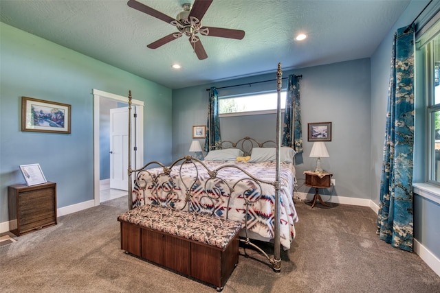 bedroom with ceiling fan, a textured ceiling, and carpet floors