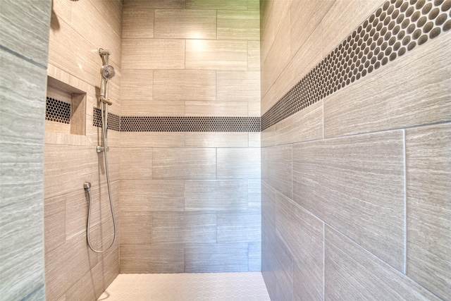 bathroom with a tile shower