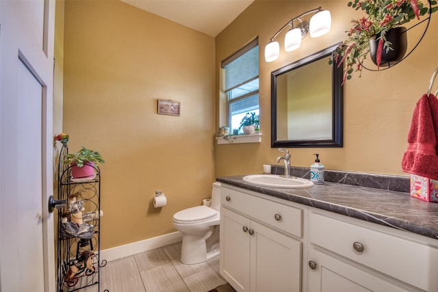 bathroom with toilet and vanity