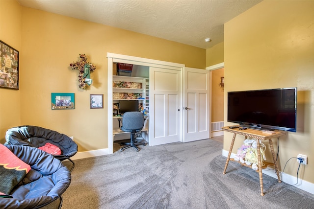 office with a textured ceiling and light colored carpet