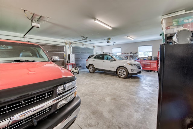 garage with black fridge and a garage door opener