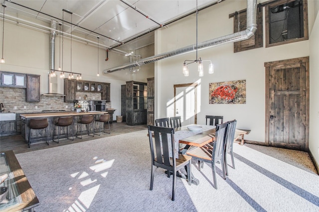 dining space featuring a high ceiling