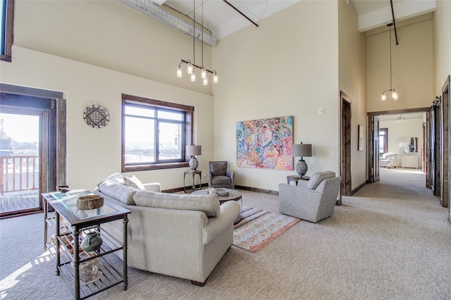 carpeted living room featuring a towering ceiling