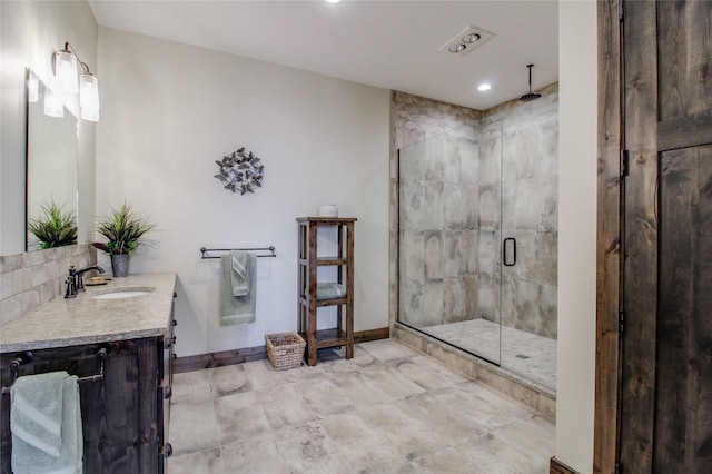 bathroom featuring vanity and a shower with shower door