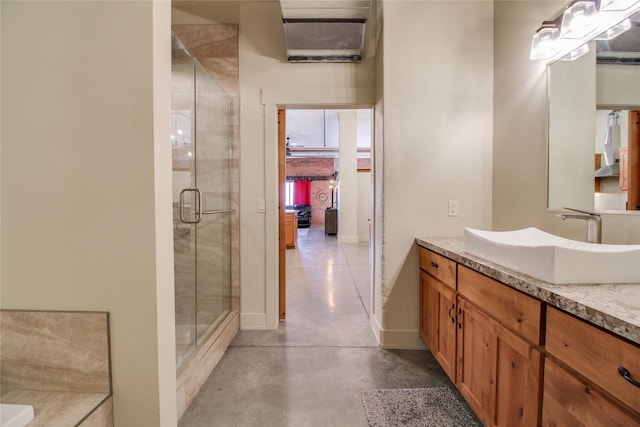 bathroom with an enclosed shower, vanity, and concrete floors