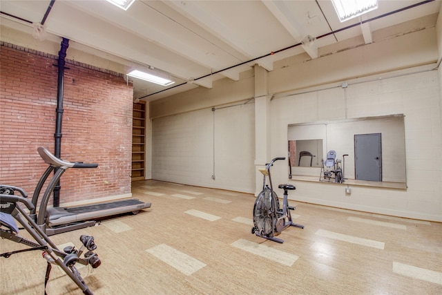 exercise area featuring brick wall