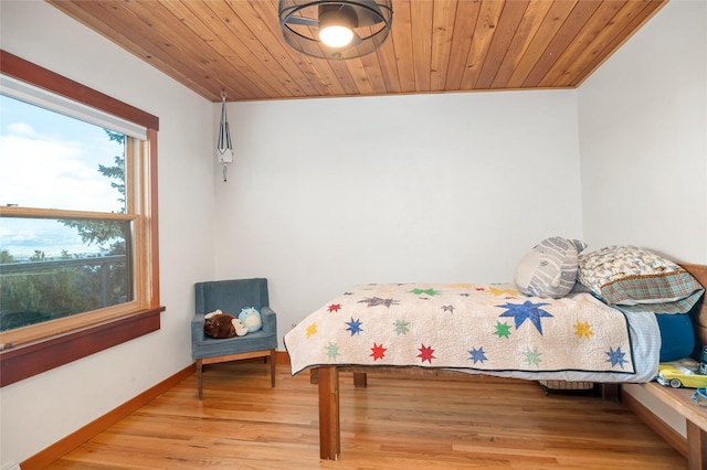 bedroom with light hardwood / wood-style floors and wooden ceiling