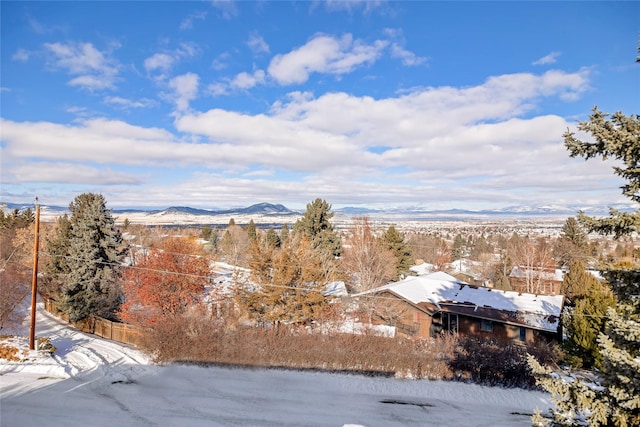 snowy aerial view with a mountain view