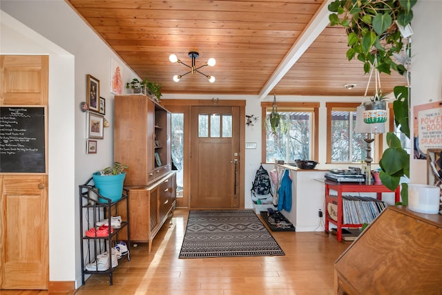 foyer entrance with wood ceiling, beamed ceiling, an inviting chandelier, and light hardwood / wood-style flooring