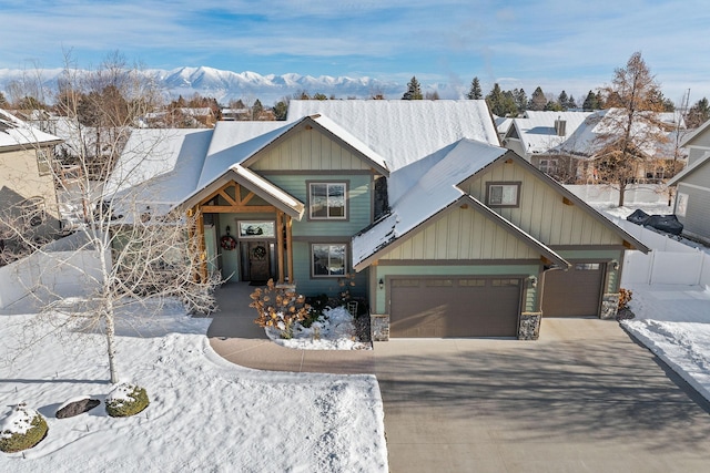 view of front of property with a garage and a mountain view