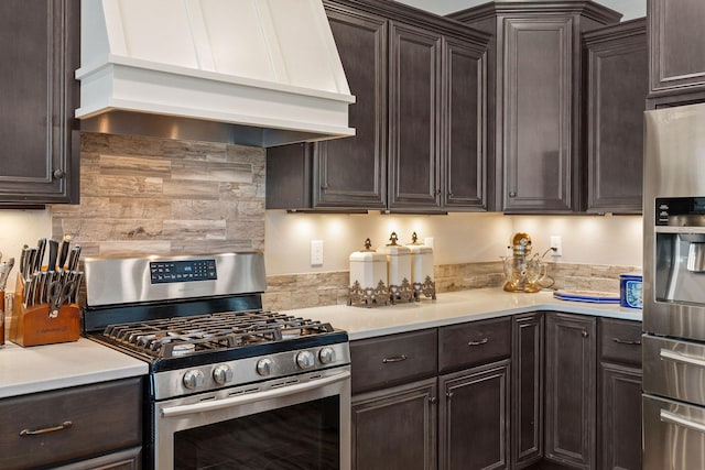 kitchen with dark brown cabinets, premium range hood, and stainless steel appliances