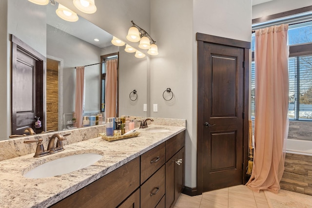 bathroom with independent shower and bath, tile patterned floors, and vanity