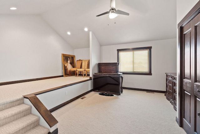 bedroom with lofted ceiling, ceiling fan, and light carpet