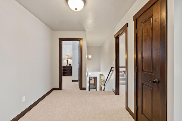 hallway featuring light colored carpet