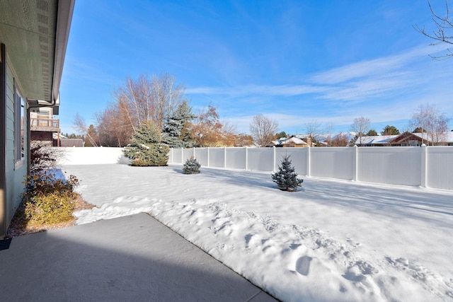 view of yard layered in snow