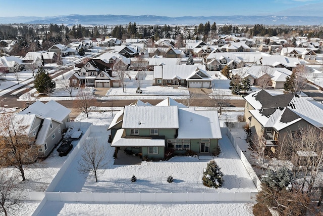 snowy aerial view featuring a mountain view