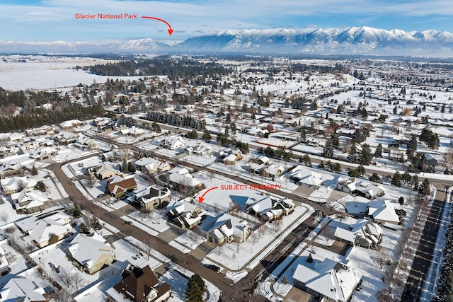 snowy aerial view featuring a mountain view