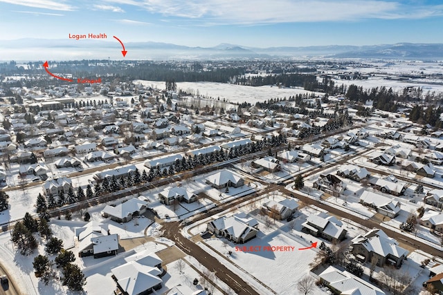 snowy aerial view featuring a mountain view